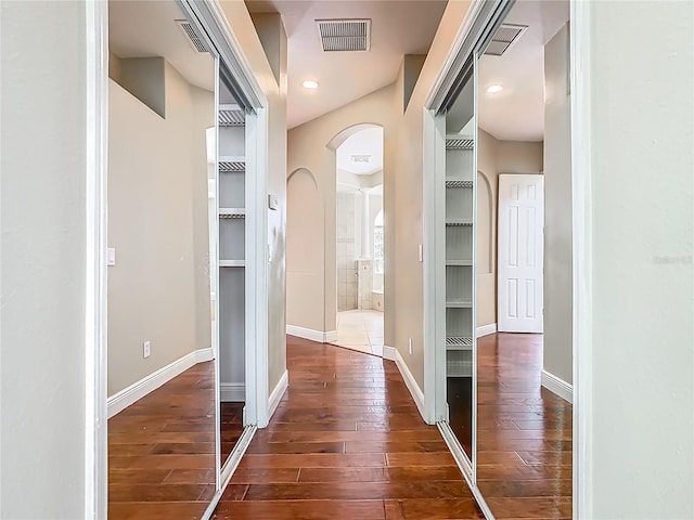 2209 Callaway Ct, Davenport, FL 33837 - hall featuring dark wood-style floors and arched walkways