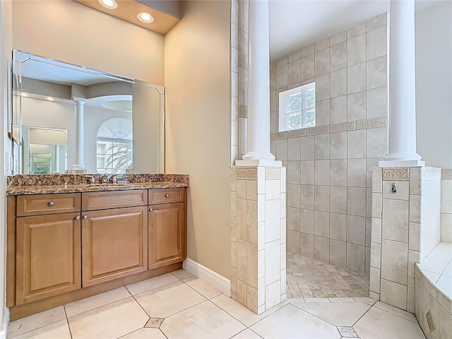2209 Callaway Ct, Davenport, FL 33837 - full bathroom featuring decorative columns, vanity, tile patterned flooring, and walk in shower