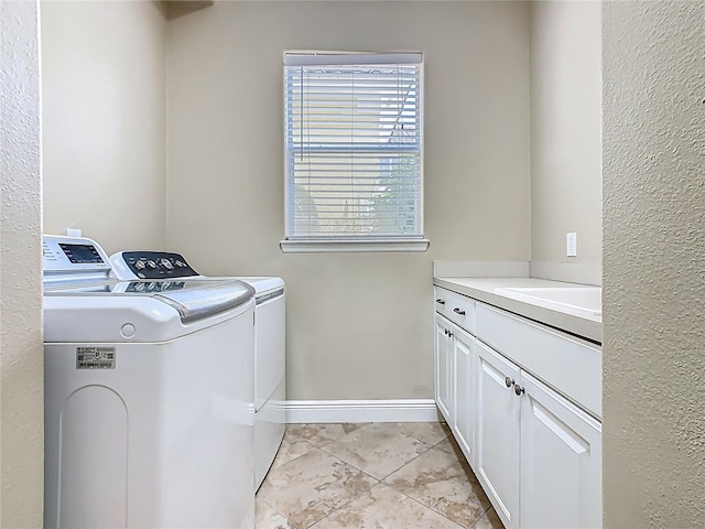 2209 Callaway Ct, Davenport, FL 33837 - laundry room featuring washer and dryer, cabinet space, and light tile patterned flooring