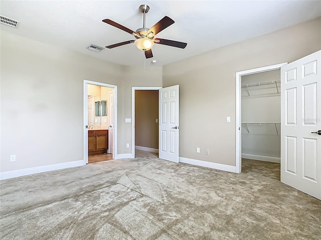 2209 Callaway Ct, Davenport, FL 33837 - unfurnished bedroom with a walk in closet, carpet floors, a closet, and a ceiling fan