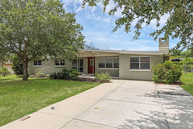 203 E Lakeview Ave, Eustis, FL 32726 - ranch-style home featuring a chimney, a front yard, and brick siding