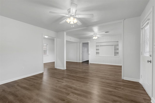 203 E Lakeview Ave, Eustis, FL 32726 - unfurnished living room with built in shelves, ceiling fan, dark wood finished floors, and healthy amount of natural light