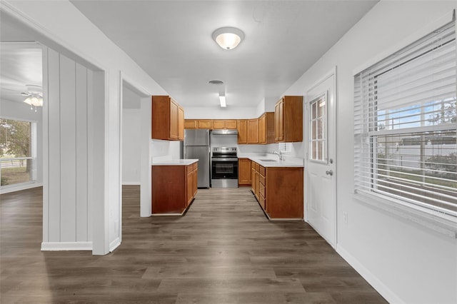 203 E Lakeview Ave, Eustis, FL 32726 - kitchen featuring appliances with stainless steel finishes, brown cabinets, healthy amount of natural light, and light countertops
