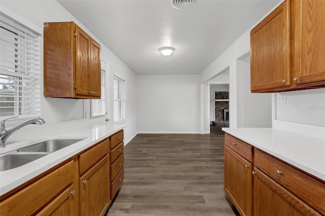 203 E Lakeview Ave, Eustis, FL 32726 - kitchen featuring light countertops, wood finished floors, a fireplace, and brown cabinets