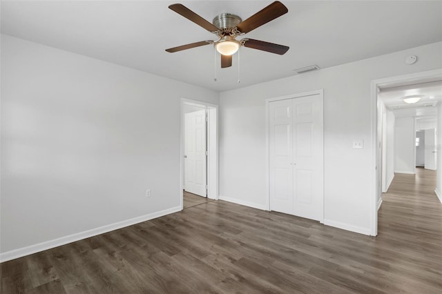 203 E Lakeview Ave, Eustis, FL 32726 - unfurnished bedroom featuring dark wood finished floors, a closet, and ceiling fan