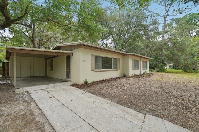 518 NW 36th Ter, Gainesville, FL 32607 - view of front of property featuring concrete block siding, driveway, and a carport