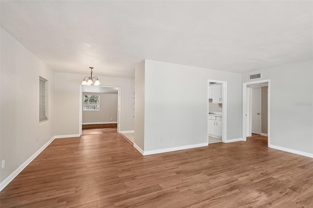 518 NW 36th Ter, Gainesville, FL 32607 - empty room with a chandelier and wood finished floors