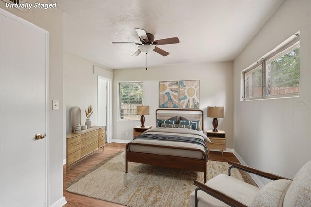 518 NW 36th Ter, Gainesville, FL 32607 - bedroom with wood finished floors and a ceiling fan