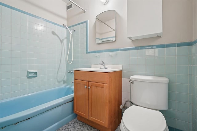 518 NW 36th Ter, Gainesville, FL 32607 - full bathroom featuring tile walls, vanity, bathtub / shower combination, and wainscoting