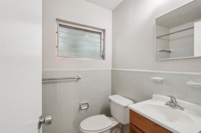 518 NW 36th Ter, Gainesville, FL 32607 - bathroom featuring tile walls, vanity, wainscoting, and a shower