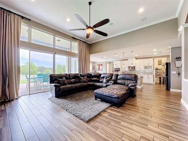 31980 Geoff Way, Sorrento, FL 32776 - living area featuring a ceiling fan, crown molding, recessed lighting, and light wood-style flooring