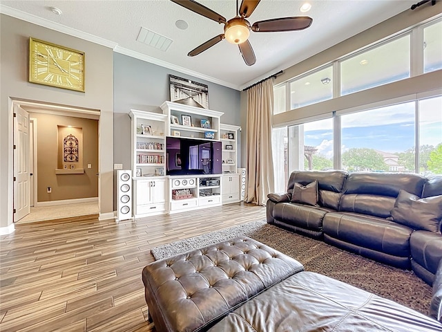 31980 Geoff Way, Sorrento, FL 32776 - living room with crown molding, ceiling fan, wood finished floors, and a towering ceiling