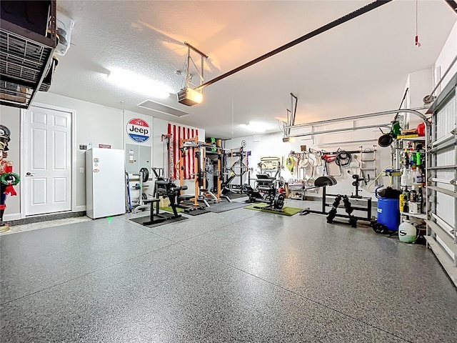 31980 Geoff Way, Sorrento, FL 32776 - garage with a garage door opener and freestanding refrigerator