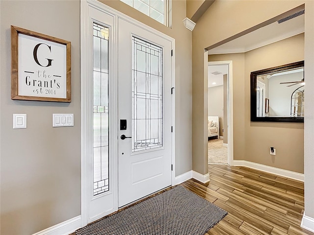 31980 Geoff Way, Sorrento, FL 32776 - foyer entrance featuring wood finished floors, healthy amount of natural light, and a ceiling fan