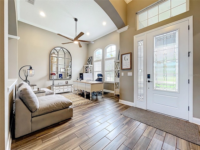31980 Geoff Way, Sorrento, FL 32776 - foyer featuring arched walkways, ceiling fan, wood finished floors, crown molding, and recessed lighting