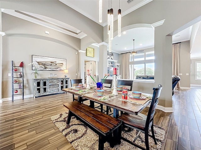 31980 Geoff Way, Sorrento, FL 32776 - dining area featuring crown molding, wood finished floors, ornate columns, and recessed lighting