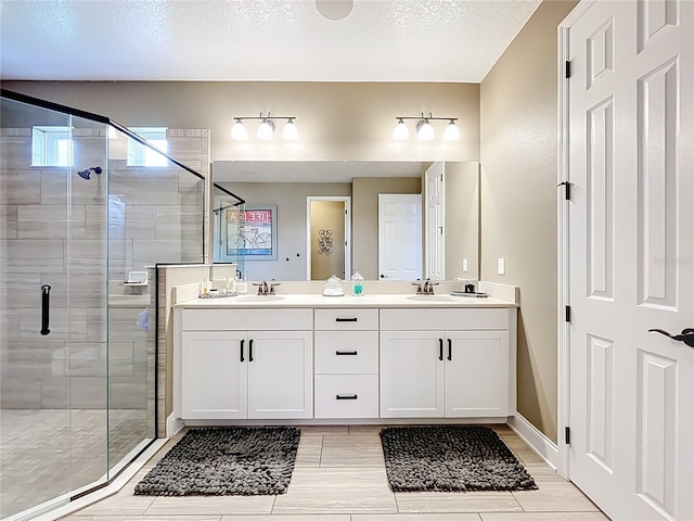 31980 Geoff Way, Sorrento, FL 32776 - bathroom featuring double vanity, a shower stall, healthy amount of natural light, and a textured ceiling