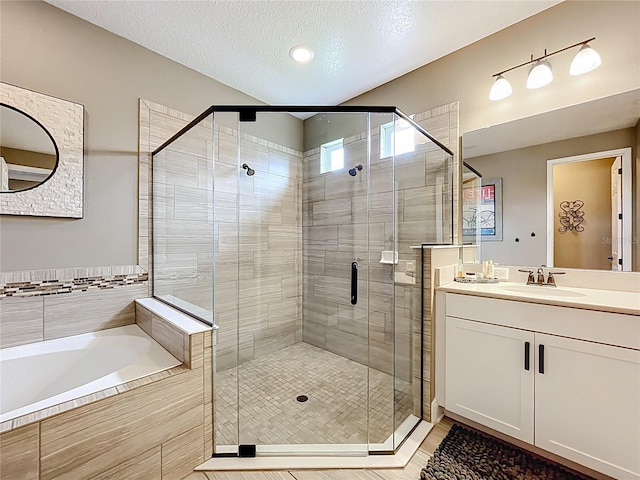 31980 Geoff Way, Sorrento, FL 32776 - full bathroom featuring a bath, a shower stall, vanity, and a textured ceiling
