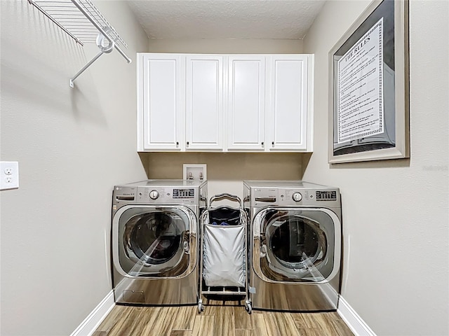31980 Geoff Way, Sorrento, FL 32776 - laundry room with cabinet space, separate washer and dryer, wood finished floors, and a textured ceiling