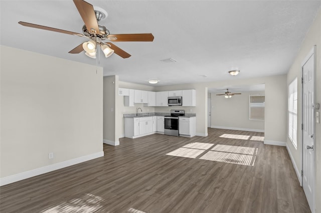 7612 Pomelo Dr, Orlando, FL 32819 - unfurnished living room with a ceiling fan and dark wood-style floors