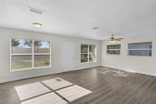 7612 Pomelo Dr, Orlando, FL 32819 - unfurnished living room featuring wood finished floors, ceiling fan, and a textured ceiling