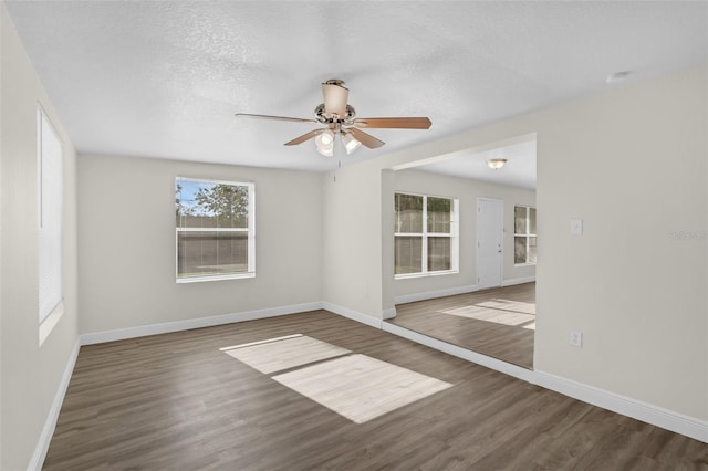 7612 Pomelo Dr, Orlando, FL 32819 - unfurnished room with healthy amount of natural light, ceiling fan, wood finished floors, and a textured ceiling