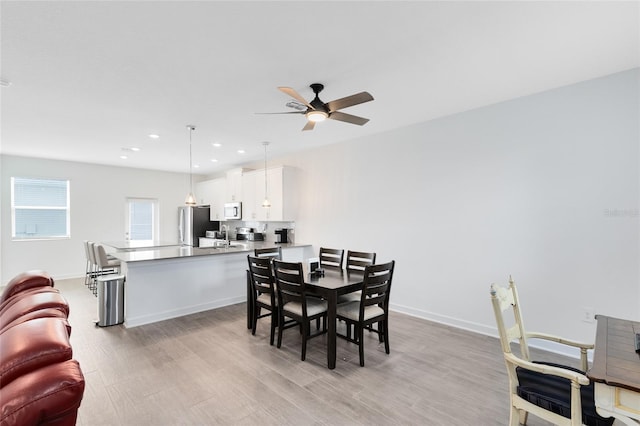 3099 Ella Way, Saint Cloud, FL 34771 - dining area with light wood-type flooring, ceiling fan, and recessed lighting