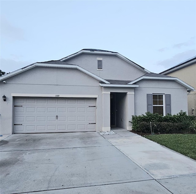 1588 Diamond Loop Dr, Kissimmee, FL 34744 - single story home with a garage, stucco siding, and concrete driveway