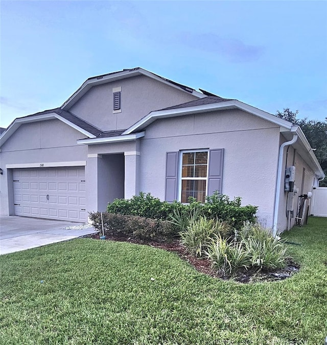 1588 Diamond Loop Dr, Kissimmee, FL 34744 - view of front facade featuring stucco siding, a front lawn, a garage, and concrete driveway