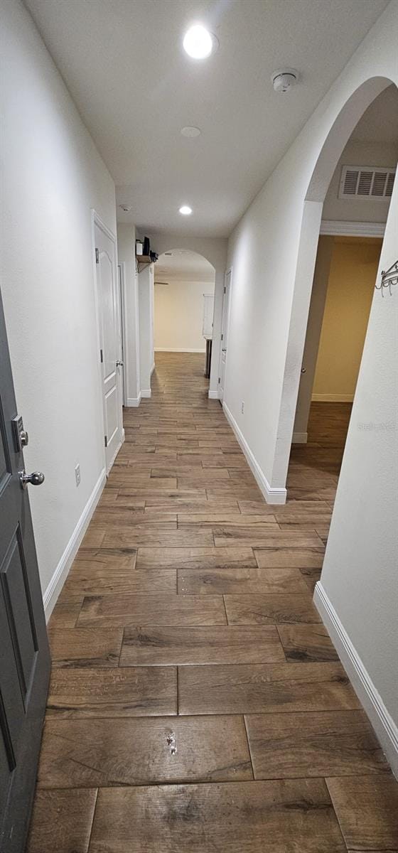 1588 Diamond Loop Dr, Kissimmee, FL 34744 - corridor with arched walkways, wood finished floors, and recessed lighting