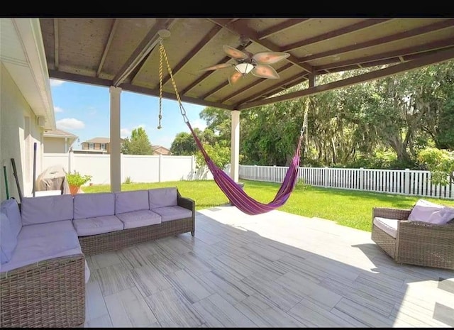 1588 Diamond Loop Dr, Kissimmee, FL 34744 - wooden terrace featuring outdoor lounge area, ceiling fan, and a fenced backyard