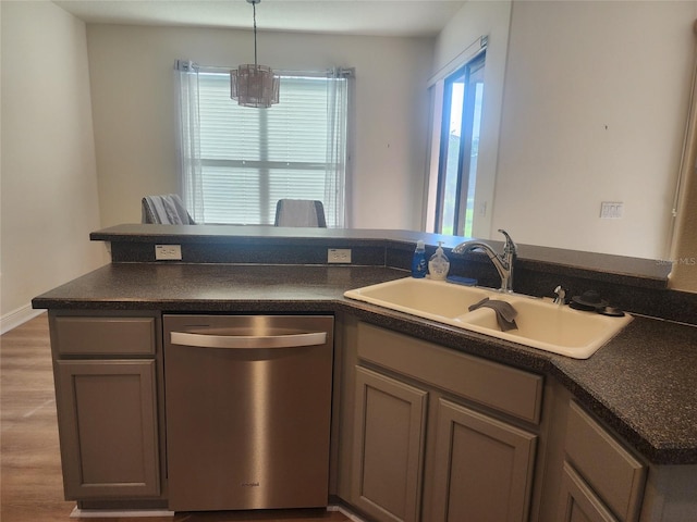 152 Glendale Ct, Kissimmee, FL 34759 - kitchen with dishwasher, dark countertops, wood finished floors, and hanging light fixtures