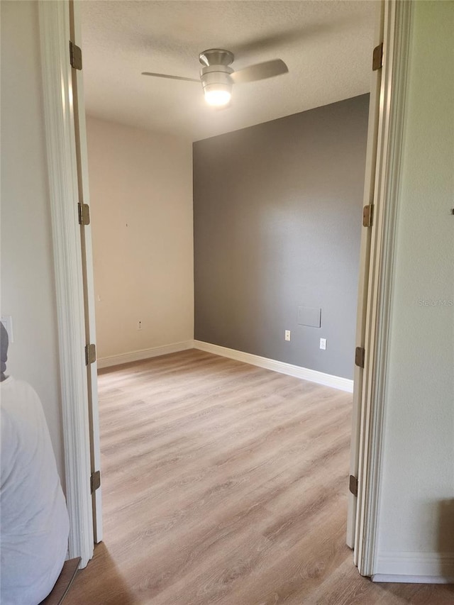 152 Glendale Ct, Kissimmee, FL 34759 - spare room with light wood finished floors, ceiling fan, and a textured ceiling