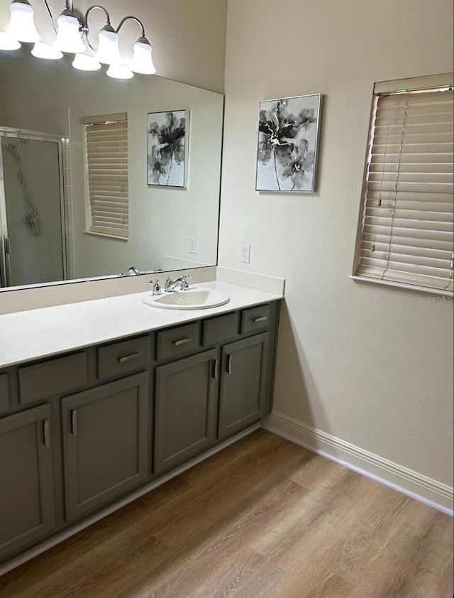 152 Glendale Ct, Kissimmee, FL 34759 - full bath featuring wood finished floors, vanity, and a shower stall