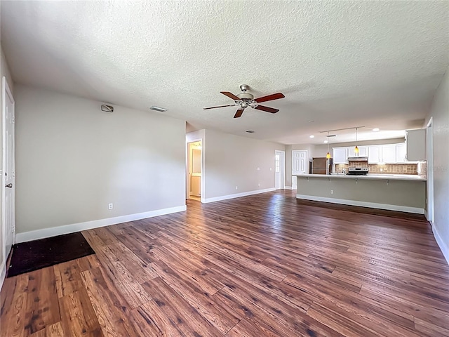 117 Burns Ave, Longwood, FL 32750 - unfurnished living room with dark wood-style floors, ceiling fan, and a textured ceiling