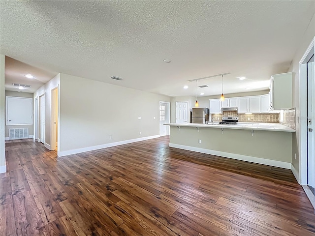 117 Burns Ave, Longwood, FL 32750 - unfurnished living room featuring dark wood finished floors and a textured ceiling