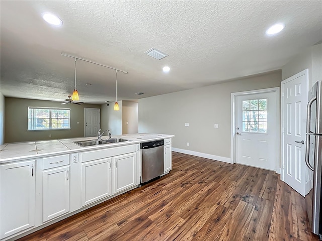 117 Burns Ave, Longwood, FL 32750 - kitchen with stainless steel appliances, dark wood-style floors, a textured ceiling, recessed lighting, and light countertops