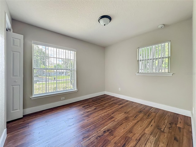 117 Burns Ave, Longwood, FL 32750 - empty room featuring dark wood-style flooring, a smoke detector, and a textured ceiling