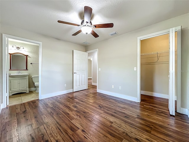 117 Burns Ave, Longwood, FL 32750 - unfurnished bedroom with hardwood / wood-style flooring, a closet, connected bathroom, a spacious closet, and a ceiling fan