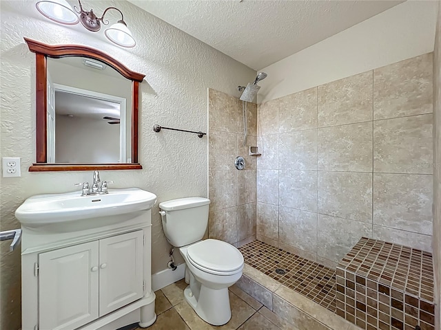 117 Burns Ave, Longwood, FL 32750 - full bathroom featuring a textured wall, tiled shower, a textured ceiling, vanity, and tile patterned flooring