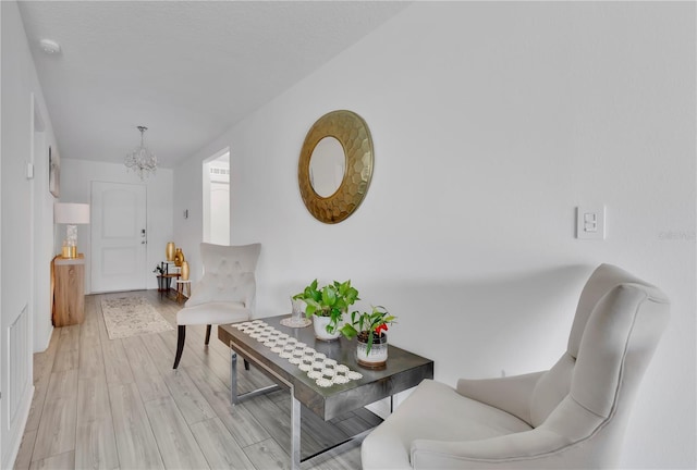 205 Cimarron Dr, Kissimmee, FL 34759 - sitting room with a chandelier and light wood-style flooring