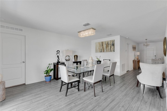 205 Cimarron Dr, Kissimmee, FL 34759 - dining space with a chandelier and light wood-style floors