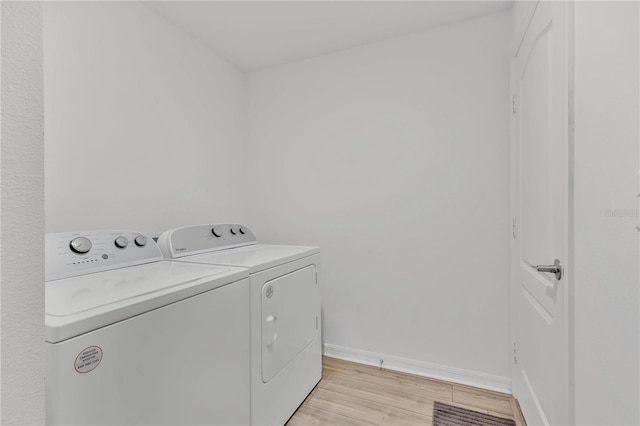 205 Cimarron Dr, Kissimmee, FL 34759 - laundry area featuring washing machine and dryer and light wood-type flooring