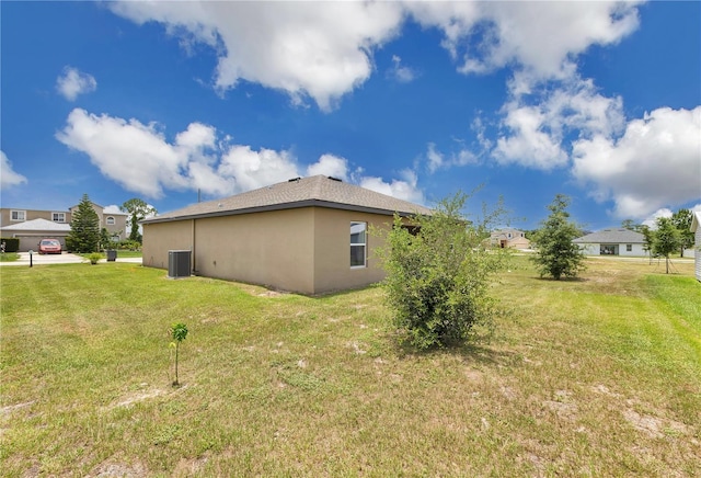205 Cimarron Dr, Kissimmee, FL 34759 - view of side of property with a lawn and stucco siding