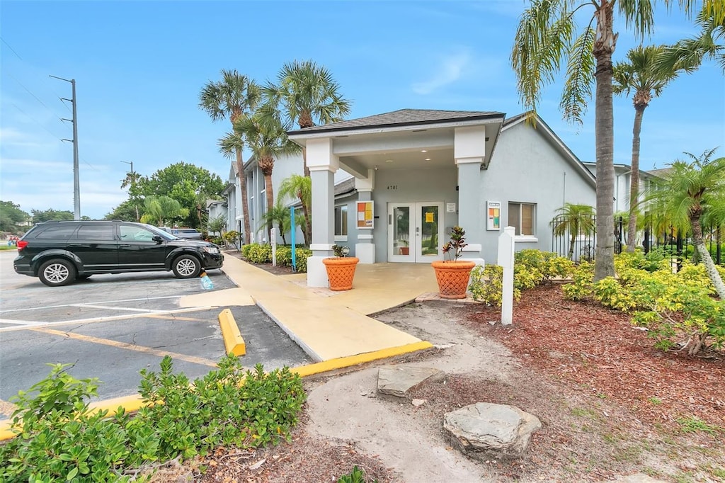 4701 S Texas Ave Unit 4701A, Orlando, FL 32839 - back of house featuring french doors, uncovered parking, and stucco siding