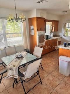 dining room featuring tile patterned floors and a chandelier