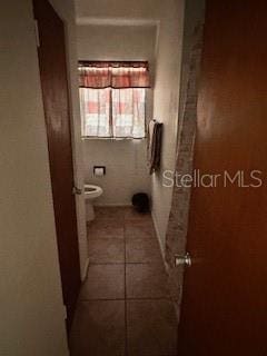 bathroom with tile patterned floors and toilet
