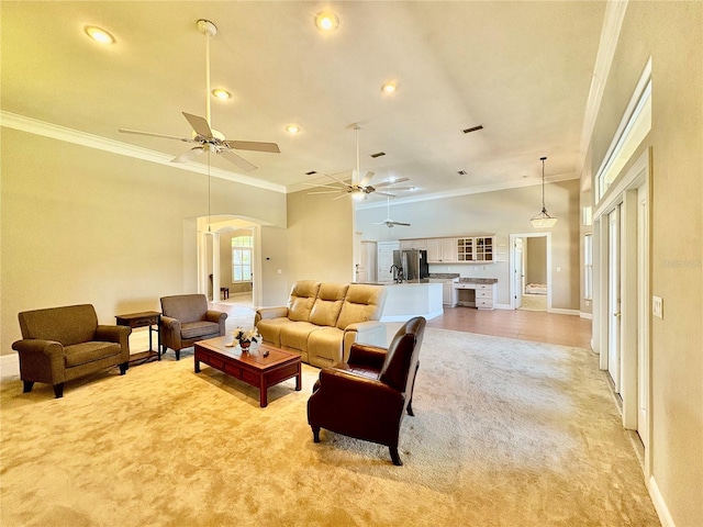 800 Sterling Chase Dr, Port Orange, FL 32128 - living area with crown molding, light colored carpet, ceiling fan, recessed lighting, and arched walkways