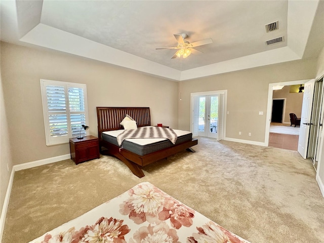 800 Sterling Chase Dr, Port Orange, FL 32128 - carpeted bedroom featuring a tray ceiling, french doors, and access to exterior