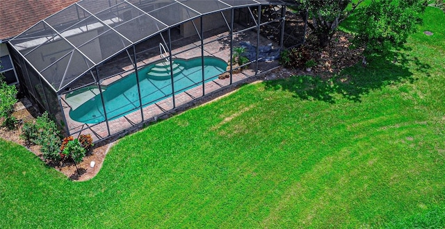 800 Sterling Chase Dr, Port Orange, FL 32128 - outdoor pool featuring glass enclosure, a hot tub, a lawn, and a patio